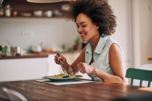 Woman with perfect teeth eating food