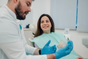 Young patient learning more about dentures