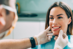 Implant dentist examining a patient’s teeth